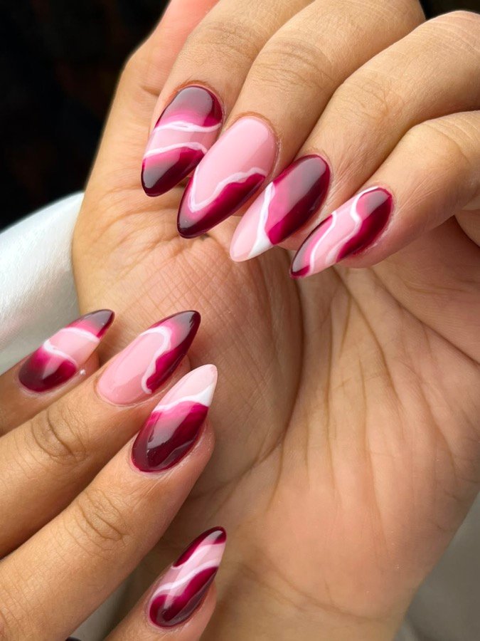 Deep red long nails styled on soft fur